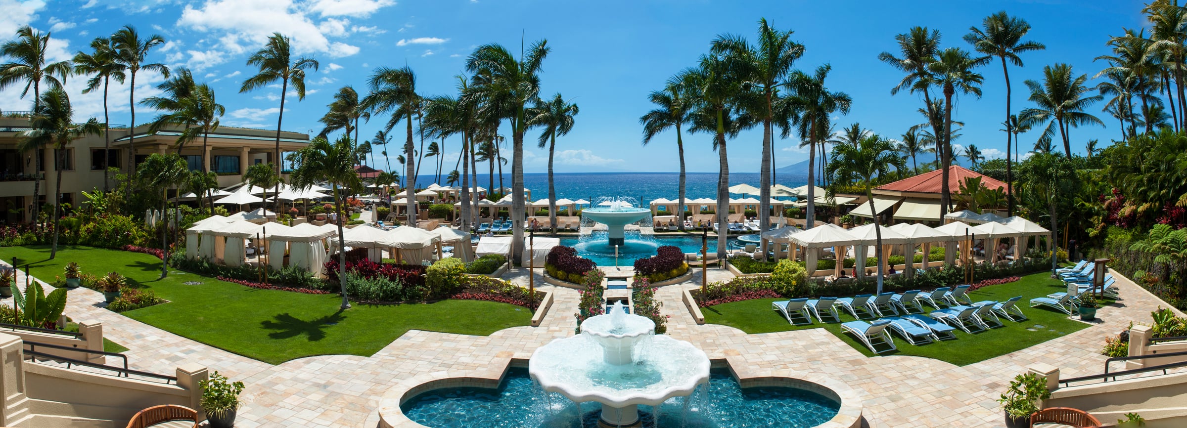 The resort grounds at Wailea, palm-lined pools and fountains framing the coastline
