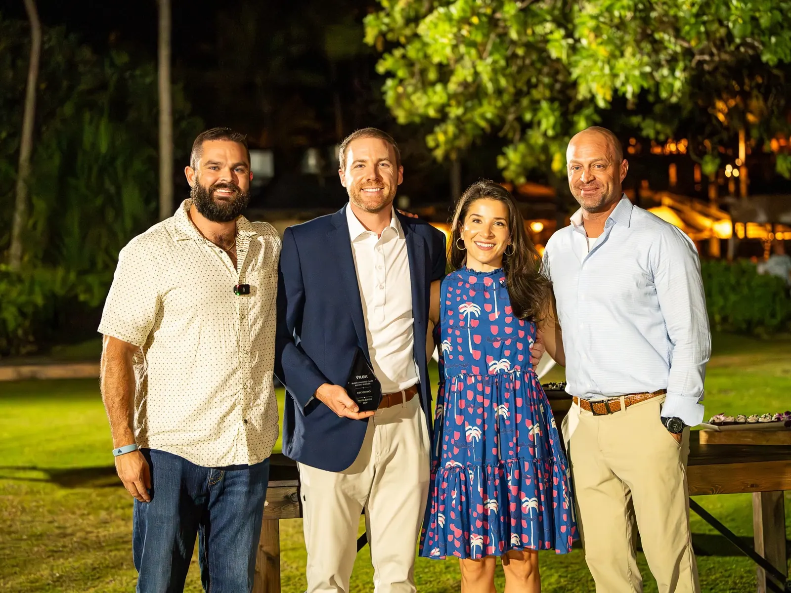 The ABC Ortho team on the lawn at the 2024 awards night, holding their Quota Buster award.