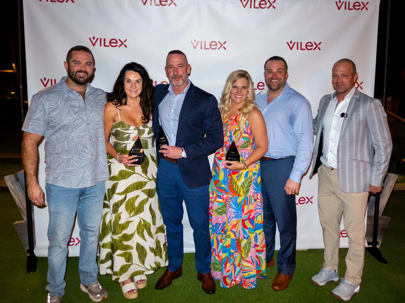 The B1 Solutions team on the Black Diamond Club step and repeat, holding their 2025 awards.