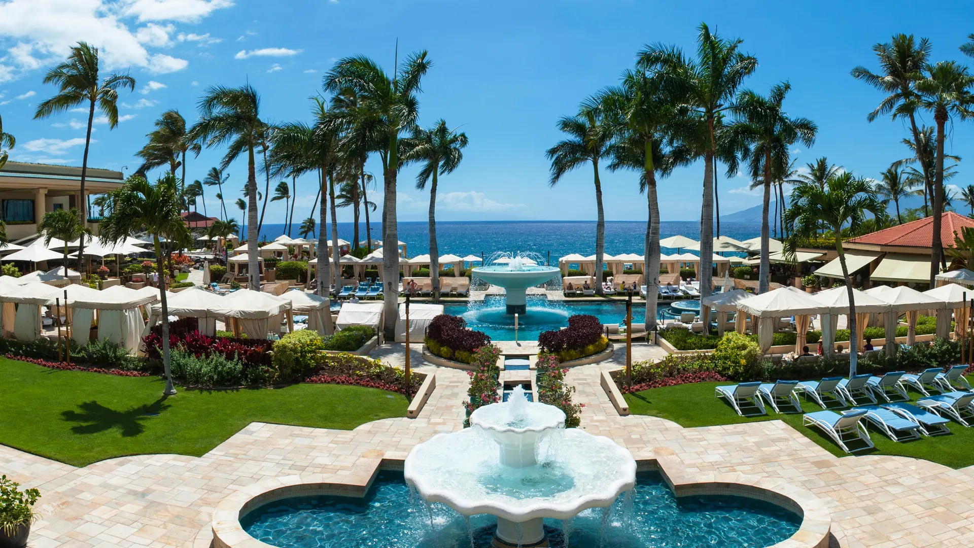 The Four Seasons Resort at Wailea, Maui: tiered fountains and palm-lined cabanas facing the open ocean.
